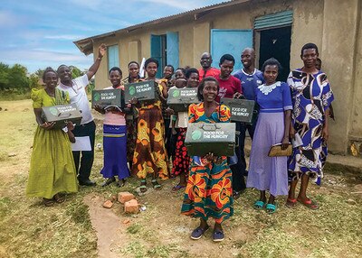 group of happy people holding safe boxes with Food for the Hungry logo on it