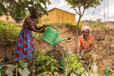 a girl and a woman smiling and farming