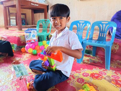 happy boy playing with mega blocks