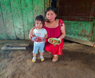 mother and daughter holding plates with food