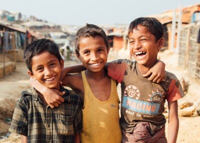 three smiling kids hugging
